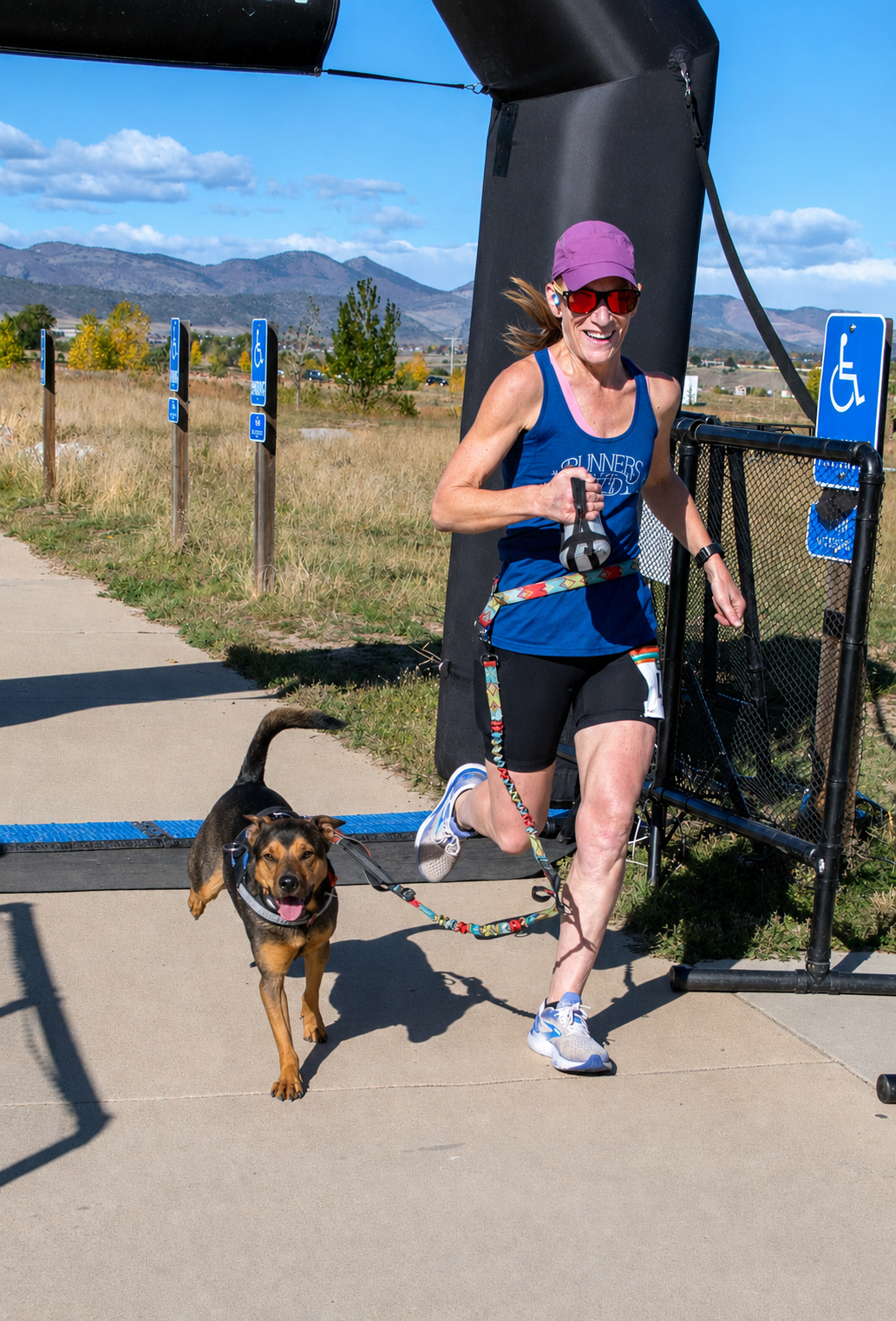 Amanda running with Summit on a leash in Colorado